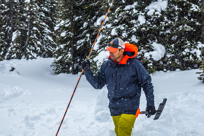 Skier practicing using his avalanche probe