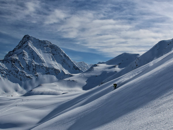 Man skiing deep powder in Mallard Valley at in the Canadian Rockies