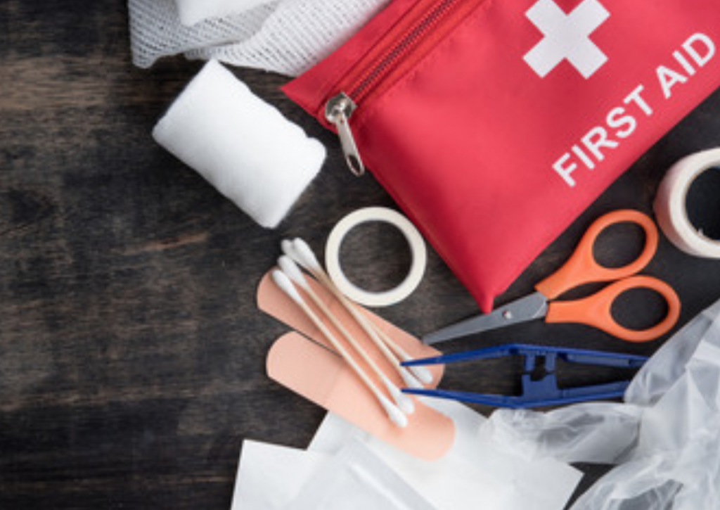 Small first aid kit open on a table to show its contents for a day trip