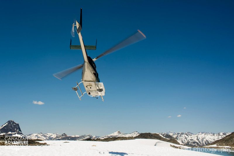 Helicopter taking off from the Mallard Mountain Lodge after dropping off hikers