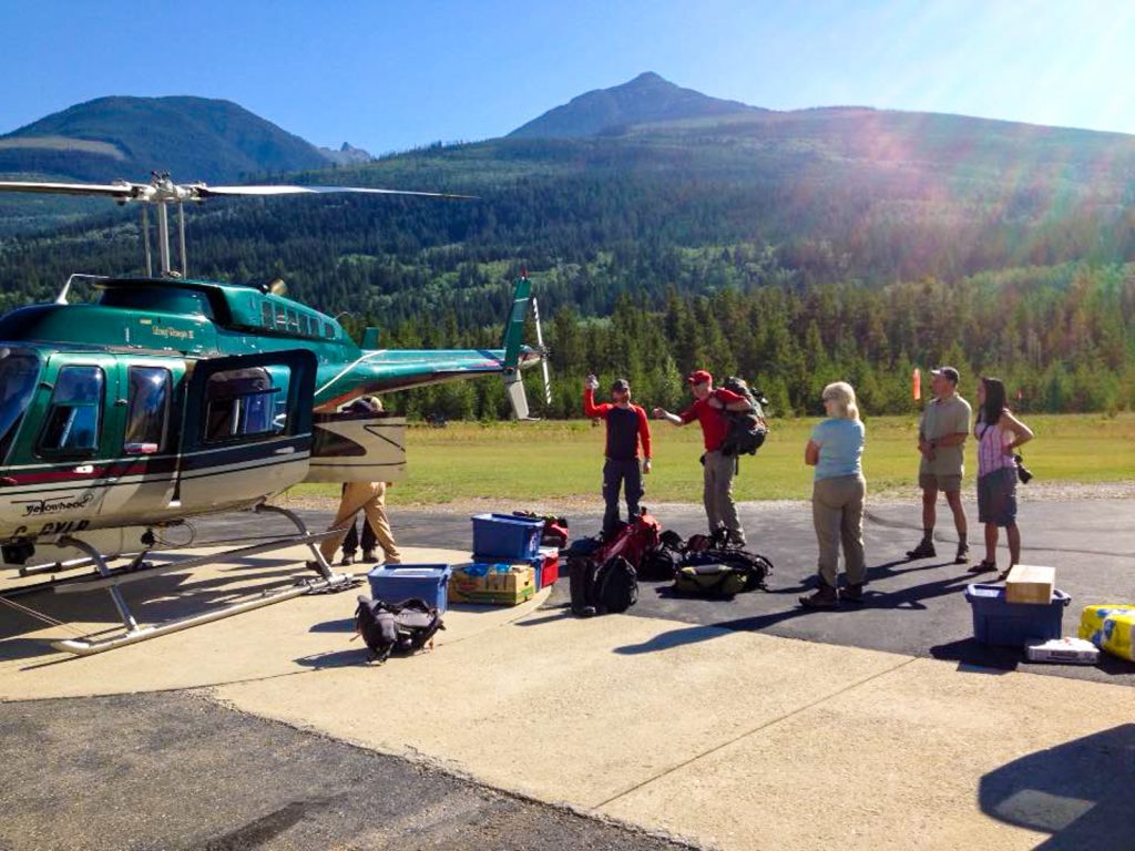 Guests loading gear into heli at Valemount for their hiking vacation