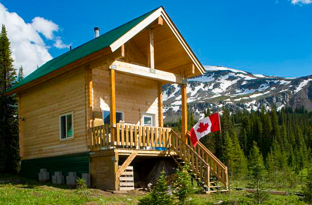 A photo of the Mallard Mountain Lodge surrounded by the Canadian Rocky Mountains.