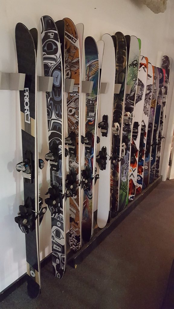 Skis and snowboards in a rack at Prior in Whistler