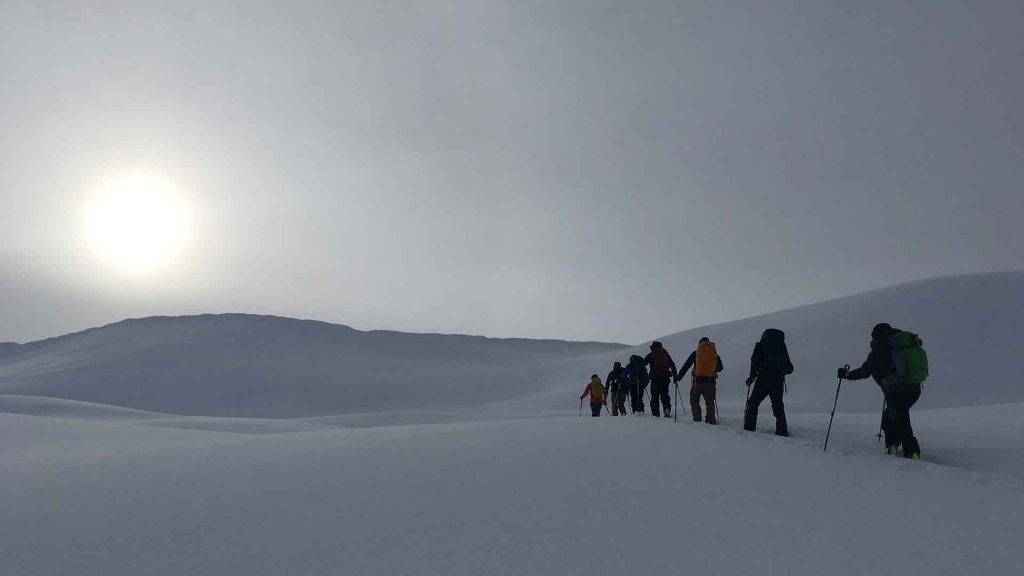 group skinning up hill