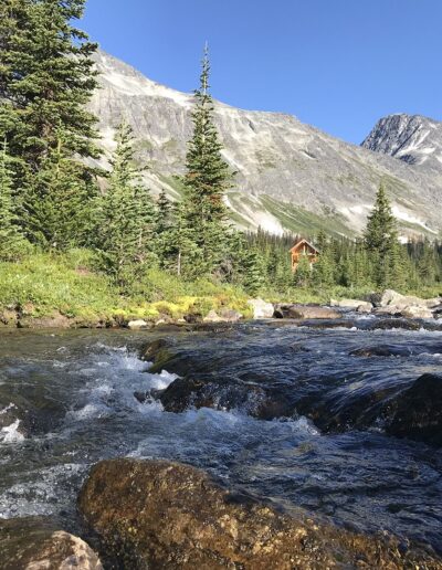 high alpine creek with lodge